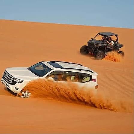 Land Cruiser dune bashing next to a buggy